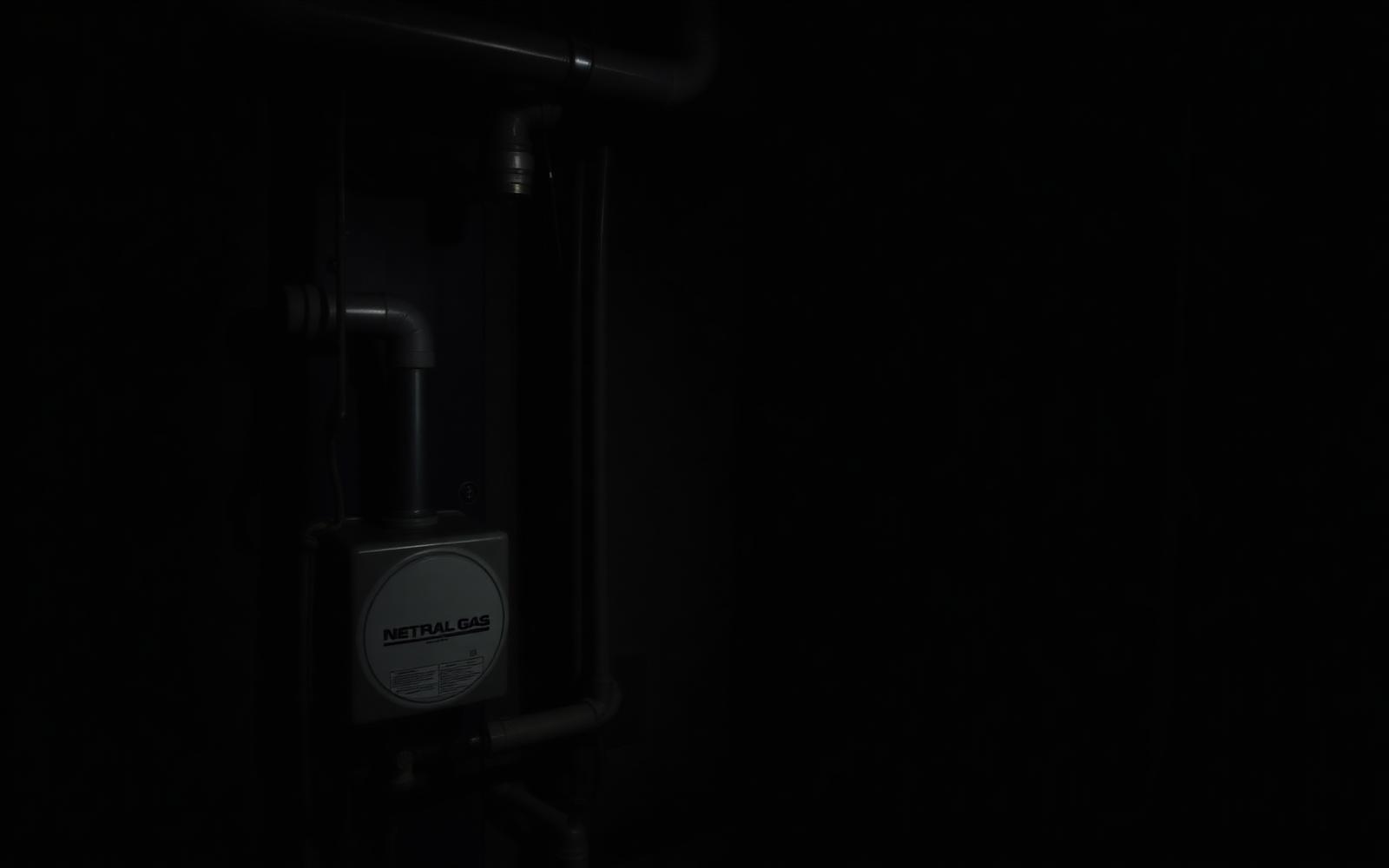 Gas meter and furnace piping in a basement utility room